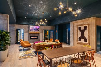 14Th floor resident clubroom with chef's kitchen, open seating area with fireplace, serving counter and dining area